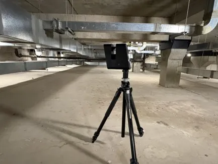 A Matterport Pro 3 scanner on a tripod capturing the plant-room basement of the Glasgow Royal Concert Hall, beneath the building's M&E services